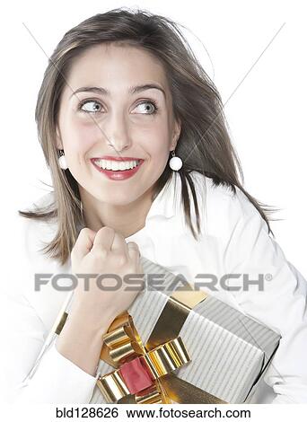 Stock Photograph - Smiling woman holding wrapped gift. Fotosearch