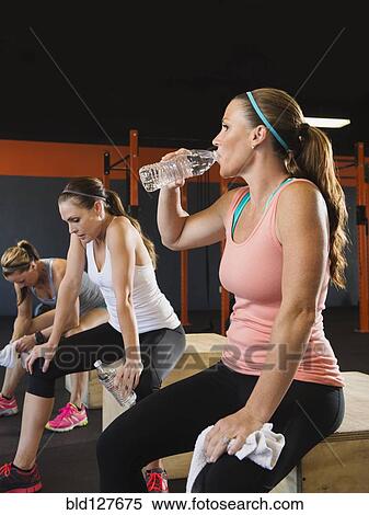 Stock Photography - Women resting together in gym. Fotosearch