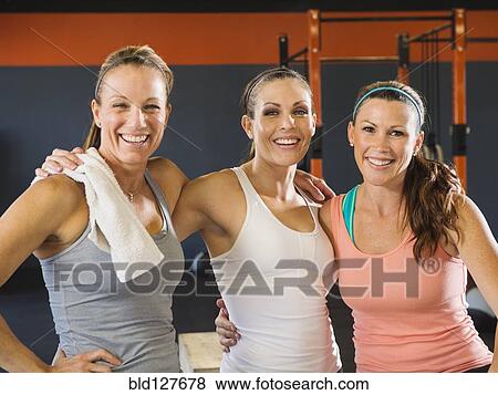 Women smiling together in gym View Large Photo Image Stock Photo - Women smiling together in gym. Fotosearch