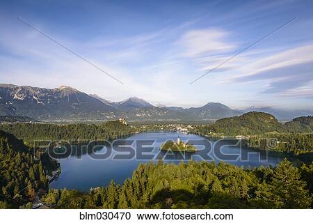 Alps mountains behind Lake Bled, Bled, Gorenjska, Slovenia View Large Photo Image Stock Image - Alps mountains behind Lake Bled, Bled, Gorenjska, Slovenia. Fotosearch