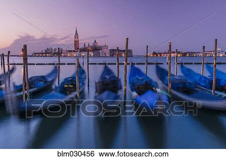 Stock Photograph - Blurred view of gondolas on urban canal, Venice, Veneto, Italy. Fotosearch
