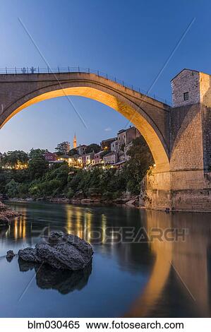 Bridge over river illuminated at dusk, Mostar, Herzegovina, Bosnia-Herzegovina View Large Photo Image Stock Photography - Bridge over river illuminated at dusk, Mostar, Herzegovina, Bosnia-Herzegovina. Fotosearch