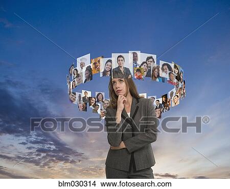 Caucasian businesswoman surrounded by faces View Large Photo Image Picture - Caucasian businesswoman surrounded by faces. Fotosearch