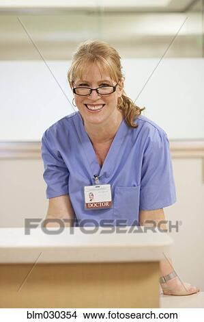 Caucasian doctor smiling in hospital View Large Photo Image Picture - Caucasian doctor smiling in hospital. Fotosearch