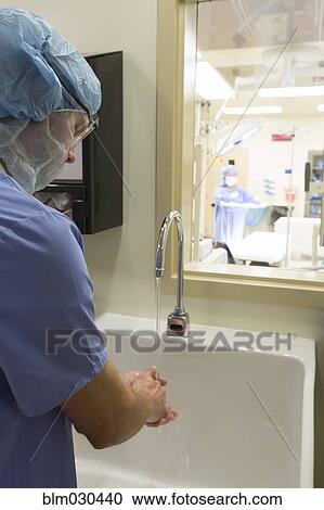Caucasian surgeon washing hands in hospital sink View Large Photo Image Stock Image - Caucasian surgeon washing hands in hospital sink. Fotosearch