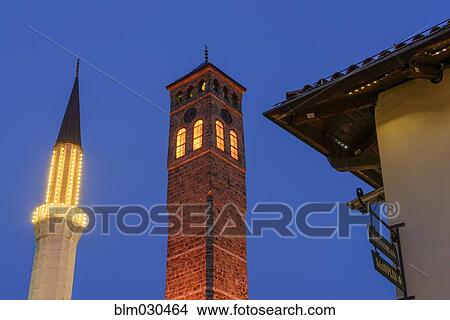 Clock tower illuminated at dusk, Sarajevo, Kanton Sarajevo, Bosnia-Herzegovina View Large Photo Image Picture - Clock tower illuminated at dusk, Sarajevo, Kanton Sarajevo, Bosnia-Herzegovina. Fotosearch
