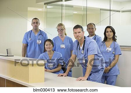 Stock Image - Doctors smiling together in hospital. Fotosearch