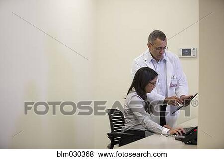 Stock Photo - Doctors talking in office. Fotosearch