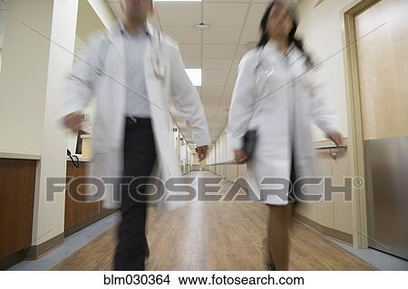 Picture - Doctors walking in hospital corridor. Fotosearch