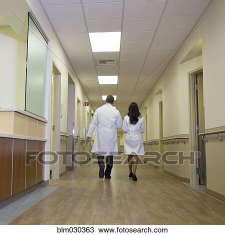 Doctors walking in hospital corridor View Large Photo Image Stock Image - Doctors walking in hospital corridor. Fotosearch