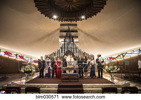 Stock Image - Family posing at wedding in church. Fotosearch