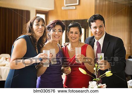 Stock Photograph - Family toasting each other at wedding reception. Fotosearch