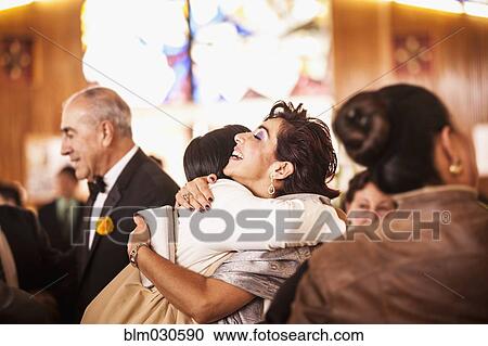 Hispanic family hugging at wedding reception View Large Photo Image Stock Image - Hispanic family hugging at wedding reception. Fotosearch