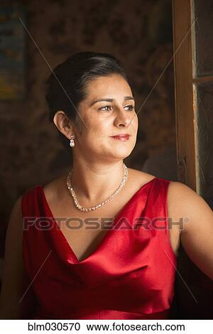 Stock Image - Hispanic woman wearing evening gown. Fotosearch
