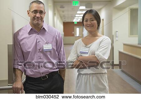 Hospital staff smiling in corridor View Large Photo Image Stock Image - Hospital staff smiling in corridor. Fotosearch
