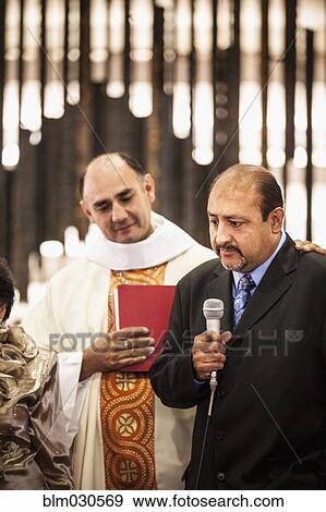 Stock Photo - Man speaking at traditional wedding. Fotosearch