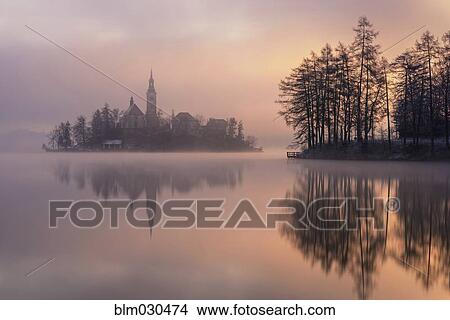 Mist shrouding island on Lake Bled at sunrise, Bled, Gorenjska, Slovenia View Large Photo Image Picture - Mist shrouding island on Lake Bled at sunrise, Bled, Gorenjska, Slovenia. Fotosearch