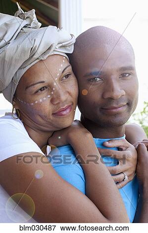 Stock Photo - Mixed race couple hugging outdoors. Fotosearch