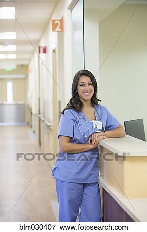 Mixed race doctor smiling in hospital corridor View Large Photo Image Stock Photo - Mixed race doctor smiling in hospital corridor. Fotosearch