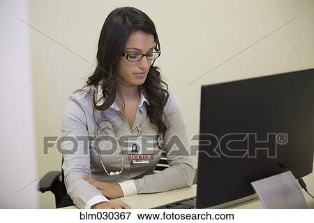 Stock Photo - Mixed race doctor working in office. Fotosearch
