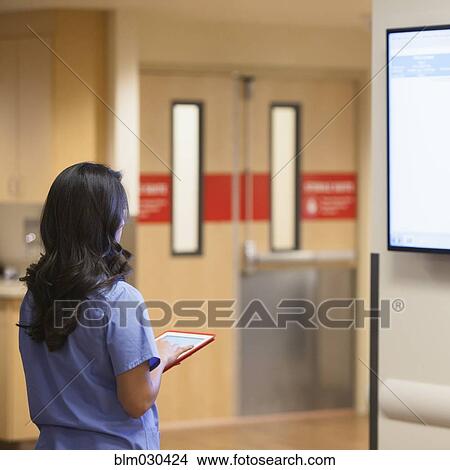 Mixed race nurse standing in hospital View Large Photo Image Picture - Mixed race nurse standing in hospital. Fotosearch