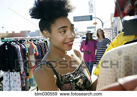 Mixed race woman shopping on city street View Large Photo Image Stock Photo - Mixed race woman shopping on city street. Fotosearch