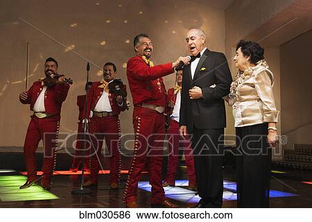Newlywed couple singing at wedding reception View Large Photo Image Stock Photograph - Newlywed couple singing at wedding reception. Fotosearch