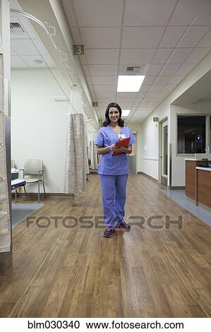 Nurse smiling in hospital View Large Photo Image Stock Image - Nurse smiling in hospital. Fotosearch
