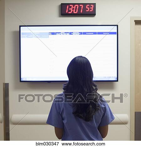 Nurse watching monitor in hospital corridor View Large Photo Image Stock Photo - Nurse watching monitor in hospital corridor. Fotosearch