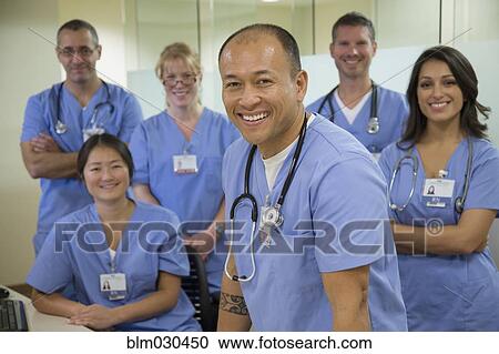 Stock Image - Nurses and doctors smiling together in hospital. Fotosearch