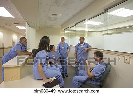 Nurses and doctors talking at nurses station View Large Photo Image Stock Photo - Nurses and doctors talking at nurses station. Fotosearch