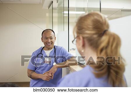 Nurses talking in hospital corridor View Large Photo Image Stock Image - Nurses talking in hospital corridor. Fotosearch