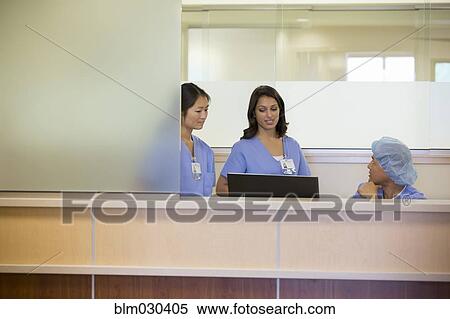 Stock Photography - Nurses talking in hospital. Fotosearch