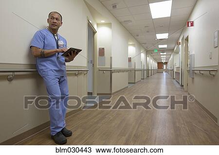 Pacific Islander nurse using digital tablet in hospital corridor View Large Photo Image Stock Image - Pacific Islander nurse using digital tablet in hospital corridor. Fotosearch