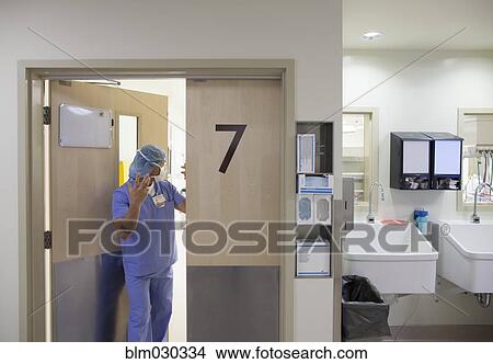 Picture - Pacific Islander surgeon leaving operating room. Fotosearch