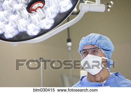 Stock Photography - Pacific Islander surgeon standing in operating room. Fotosearch