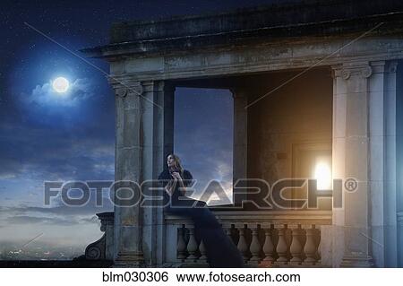Stock Photograph - Pacific Islander woman sitting on ornate balcony. Fotosearch