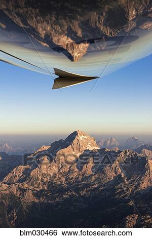 Stock Photograph - Rocky landscape reflected in belly of airplane, Julian Alps, Gorenjska, Slovenia. Fotosearch