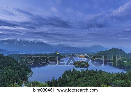 Stock Image - Still lake among rural landscape, Bled, Gorenjska, Slovenia. Fotosearch
