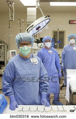 Stock Photo - Surgeons ready in operating room. Fotosearch