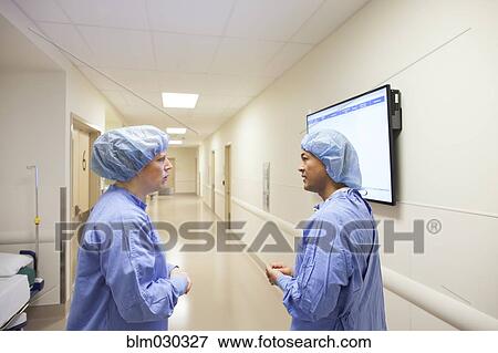 Stock Photo - Surgeons talking in hospital corridor. Fotosearch