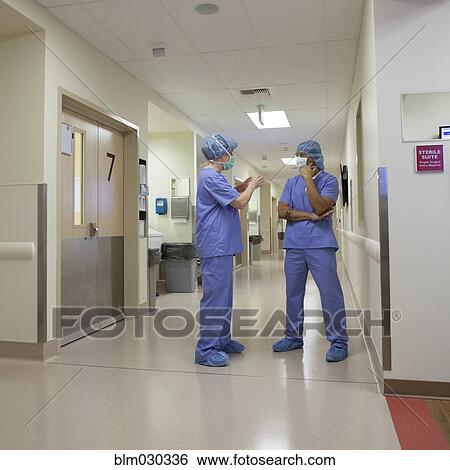 Stock Photograph - Surgeons talking in hospital corridor. Fotosearch