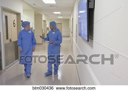 Surgeons talking in hospital corridor View Large Photo Image Stock Photograph - Surgeons talking in hospital corridor. Fotosearch