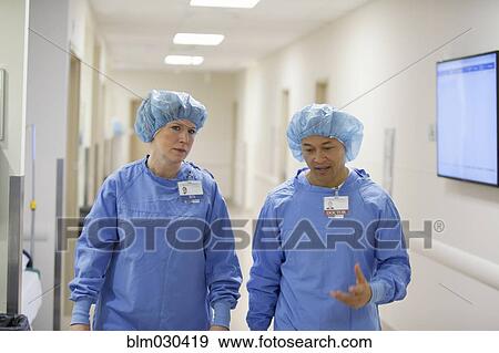Stock Photo - Surgeons walking in hospital corridor. Fotosearch