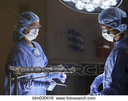 Surgeons working in operating room View Large Photo Image Stock Photograph - Surgeons working in operating room. Fotosearch