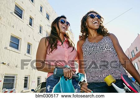 Stock Photo - Women laughing on city street. Fotosearch