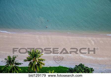 Stock Photo - Aerial view of heart-shape on tropical beach. Fotosearch