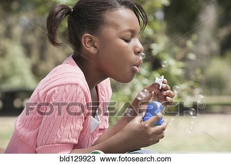 African American girl blowing bubbles outdoors View Large Photo Image Stock Image - African American girl blowing bubbles outdoors. Fotosearch