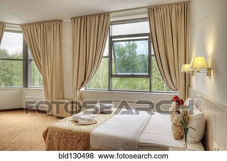 Bed and curtains in hotel room View Large Photo Image Stock Photo - Bed and curtains in hotel room. Fotosearch
