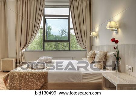Bed and curtains in hotel room View Large Photo Image Stock Photo - Bed and curtains in hotel room. Fotosearch